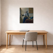 Unframed poster print of Johannes Vermeer's Young Woman with a Water Pitcher displayed on a wall in a office