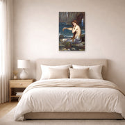 Unframed poster print of John William Waterhouse's A Mermaid displayed on a wall in a bedroom