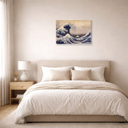 Gallery-wrapped canvas print of Katsushika Hokusai's The Great Wave Off the Coast of Kanagawa displayed on a wall in a bedroom