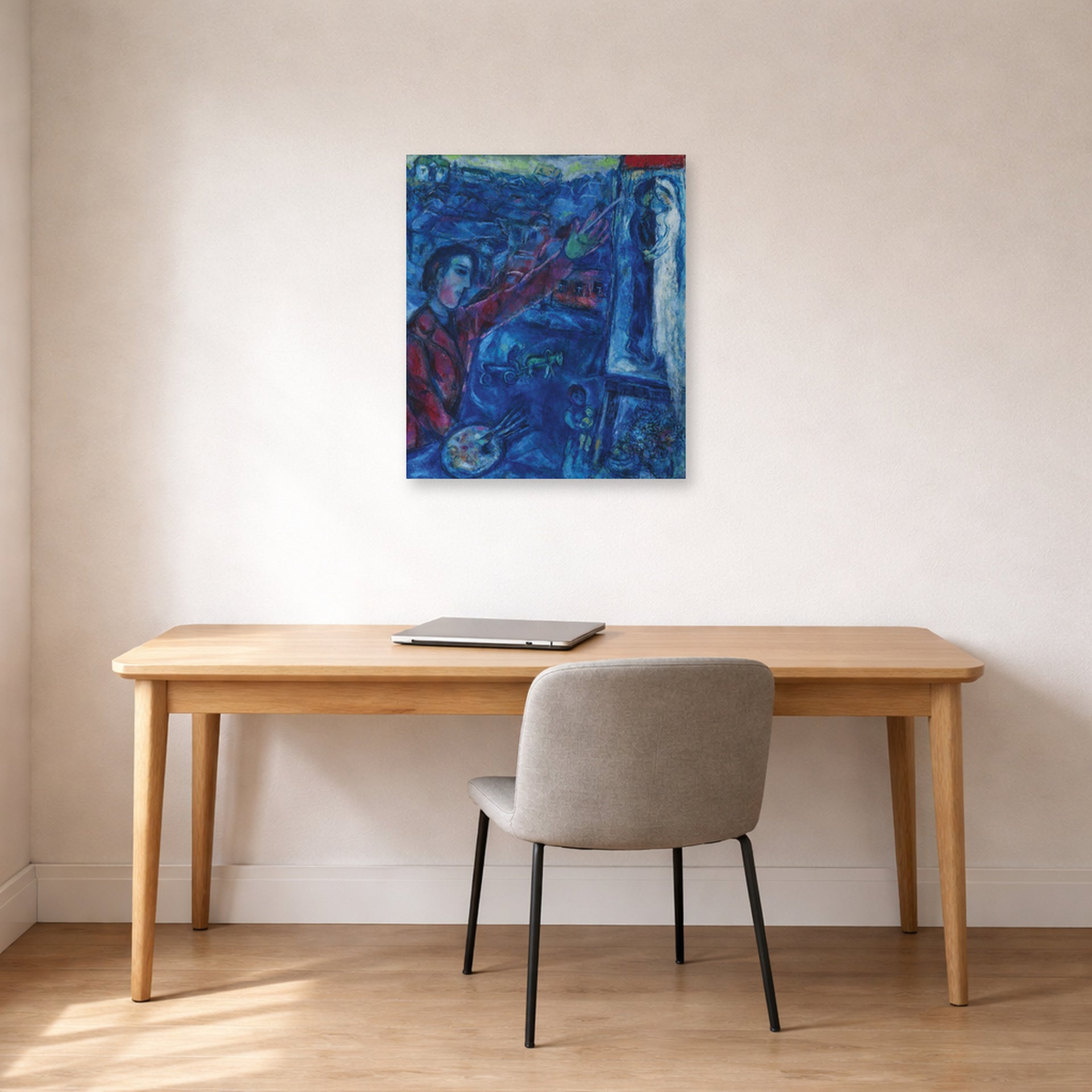 Unframed poster print of Marc Chagall's Le Peintre Devant Le Chevalet displayed on a wall in an office