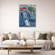 Gallery-wrapped canvas print of Marc Chagall's Les Mariés Sur Fond Bleu displayed on a wall in a living room