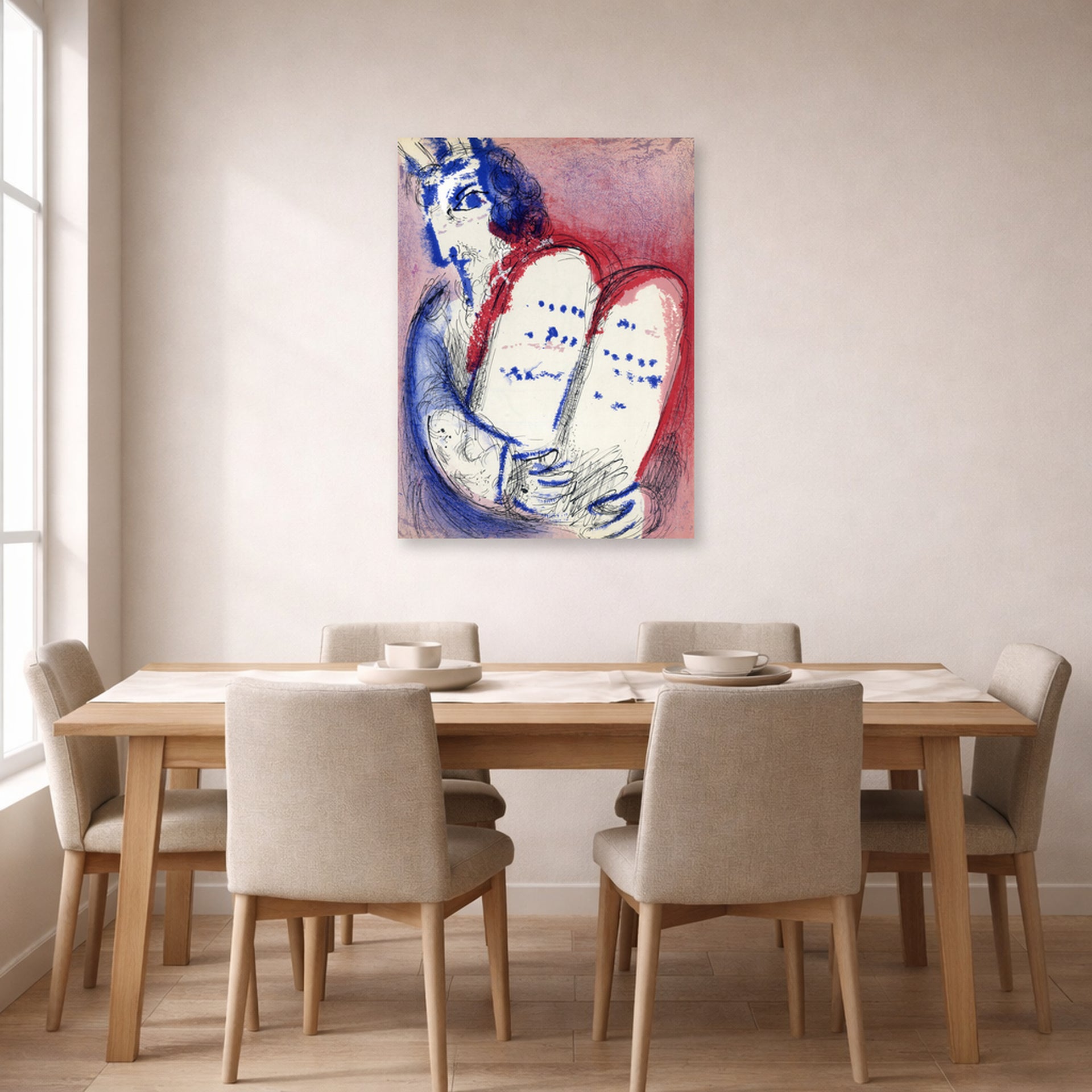 Unframed poster print of Marc Chagall's Moses with the Tablets of Law displayed on a wall in a dining room