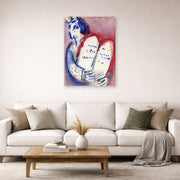 Unframed poster print of Marc Chagall's Moses with the Tablets of Law displayed on a wall in a living room