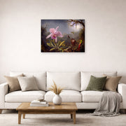 Unframed poster print of Martin Johnson Heade's 'Cattleya Orchid and Three Hummingbirds' displayed on a wall in a living room