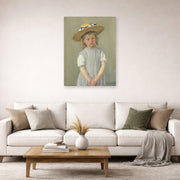 Unframed poster print of Mary Cassatt's Child in a Straw Hat displayed on a wall in a living room
