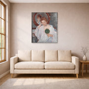 Unframed poster print of Mary Cassatt's Denise at Her Dressing Table displayed on a wall in a living room