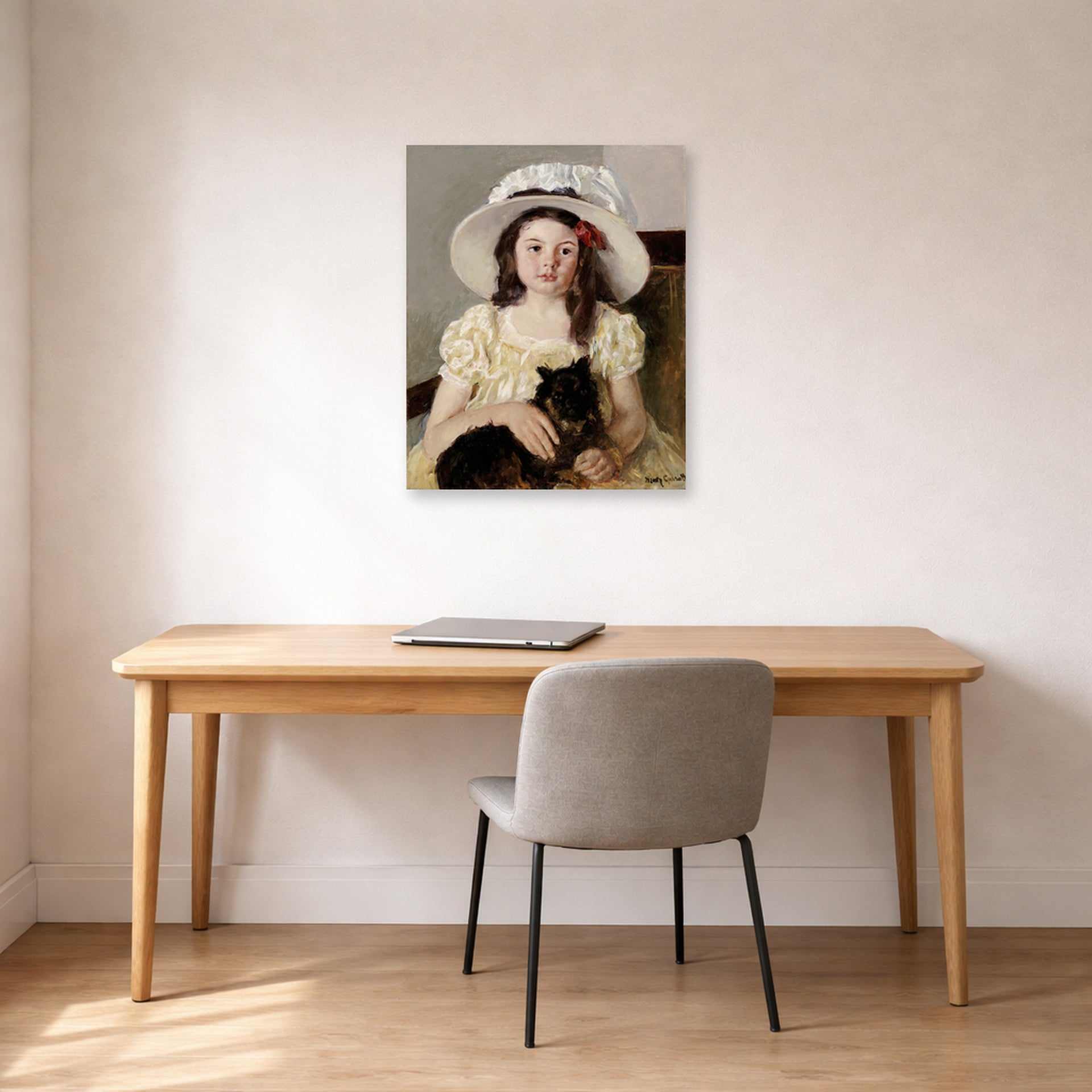 Unframed poster print of Mary Cassatt's Francoise Holding a Little Black Dog displayed on a wall in a office
