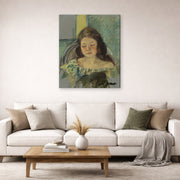 Gallery-wrapped canvas print of Mary Cassatt's Françoise in a Round Backed Chair Reading displayed on a wall in a living room