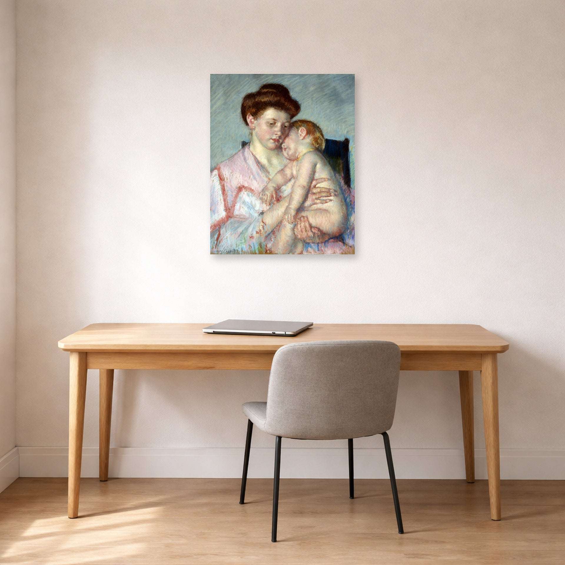Unframed poster print of Mary Cassatt's Sleepy Baby displayed on a wall in a office