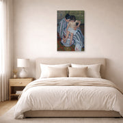 Gallery-wrapped canvas print of Mary Cassatt's The Childs Bath displayed on a wall in a bedroom
