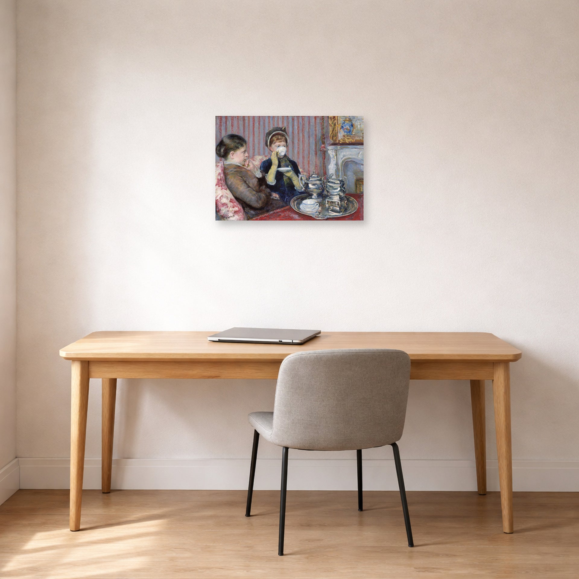 Unframed poster print of Mary Cassatt's The Tea displayed on a wall in a office