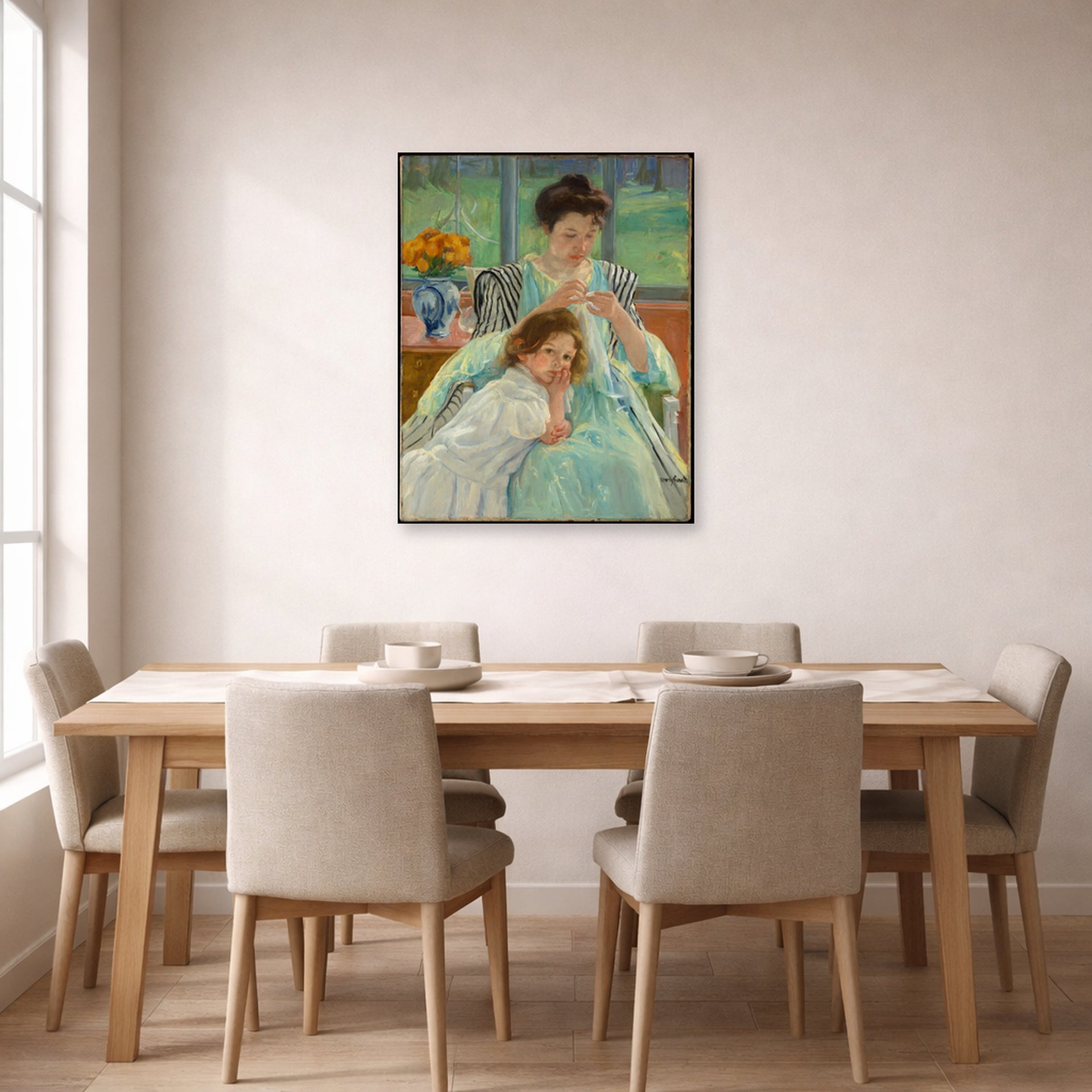 Unframed poster print of Mary Cassatt's Young Mother Sewing displayed on a wall in a dining room