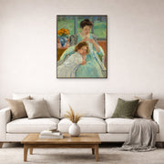 Unframed poster print of Mary Cassatt's Young Mother Sewing displayed on a wall in a living room
