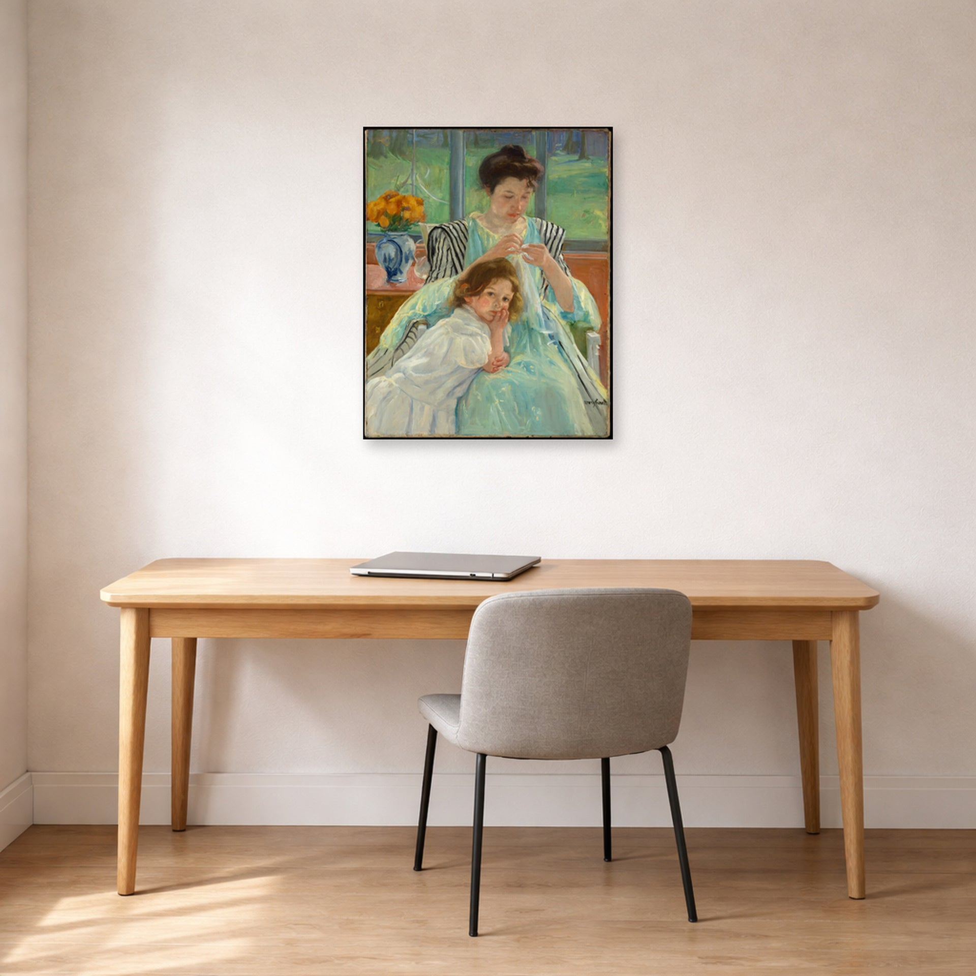 Unframed poster print of Mary Cassatt's Young Mother Sewing displayed on a wall in a office