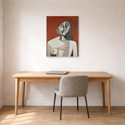 Unframed poster print of Pablo Picasso's 'Bust of a Woman' displayed on a wall in a home office
