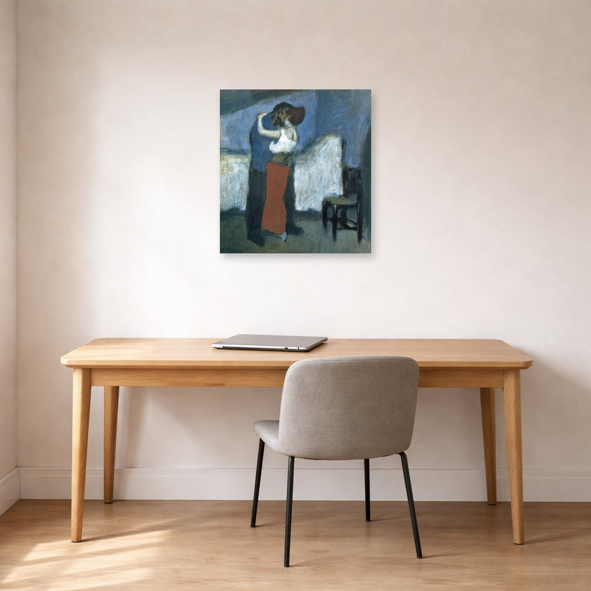 Unframed poster print of Pablo Picasso's 'Embrace' displayed on a wall in a home office