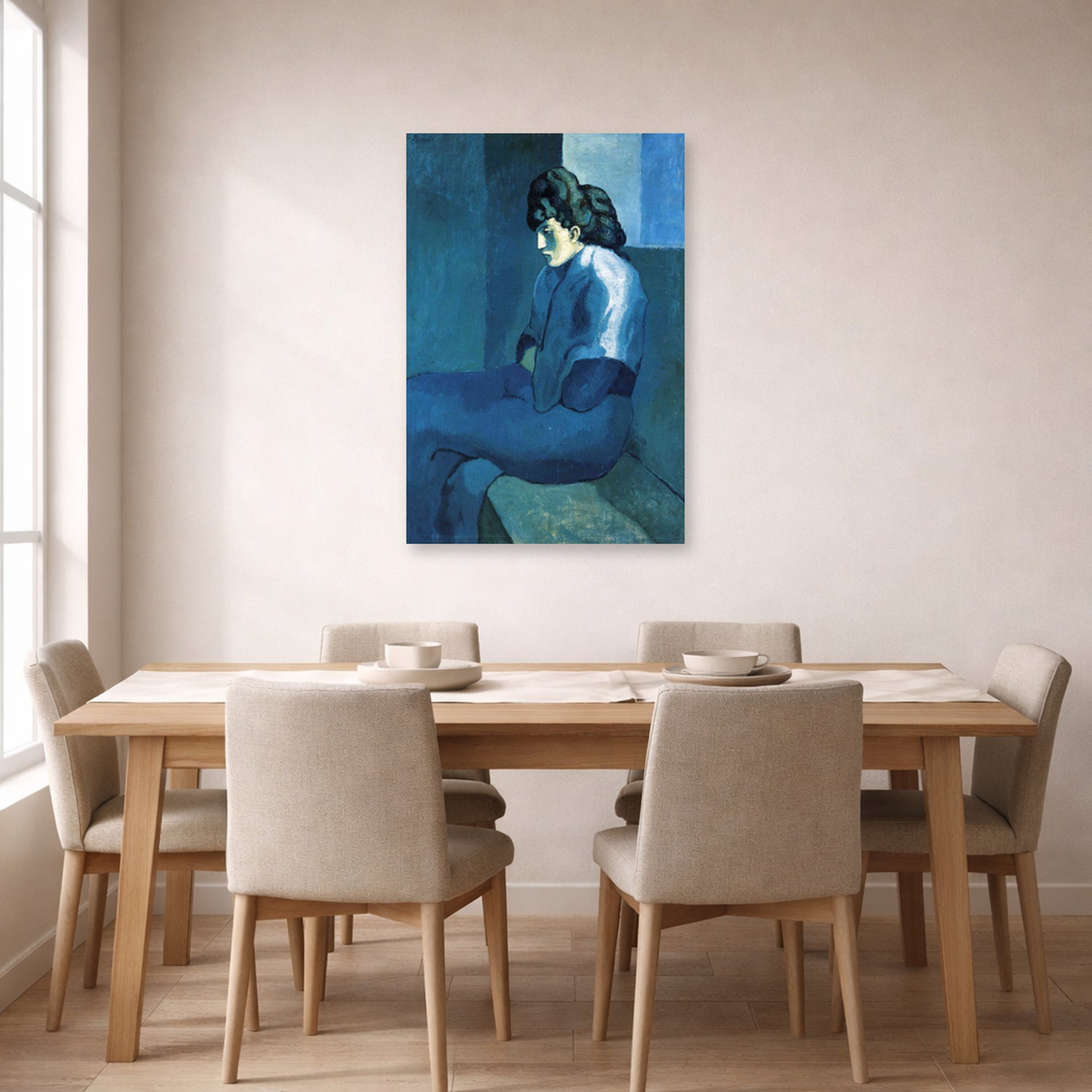 Unframed poster print of Pablo Picasso's 'Melancholy Woman' displayed on a wall in a dining room