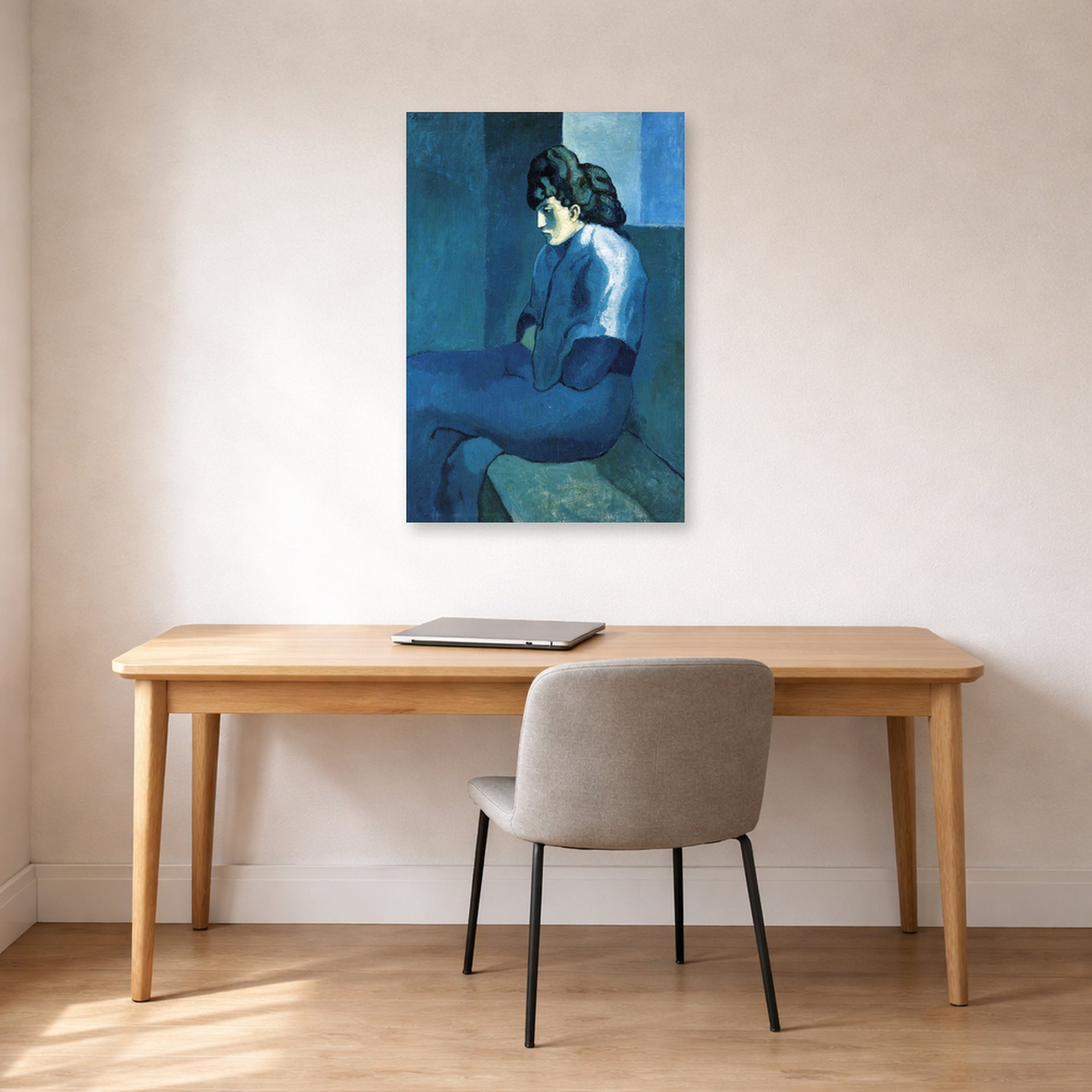 Unframed poster print of Pablo Picasso's 'Melancholy Woman' displayed on a wall in a home office