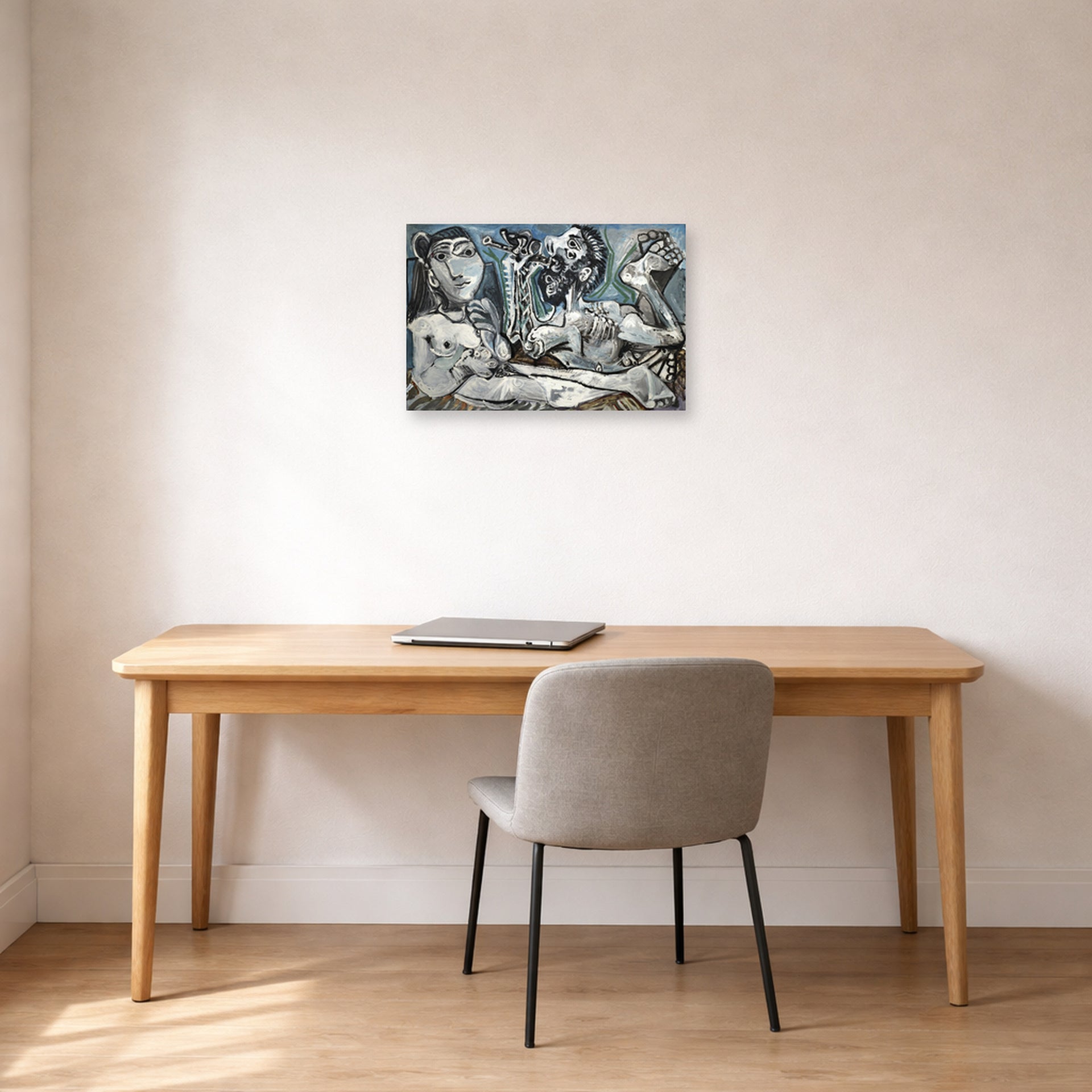 Unframed poster print of Pablo Picasso's 'Nude Lovers' displayed on a wall in a home office