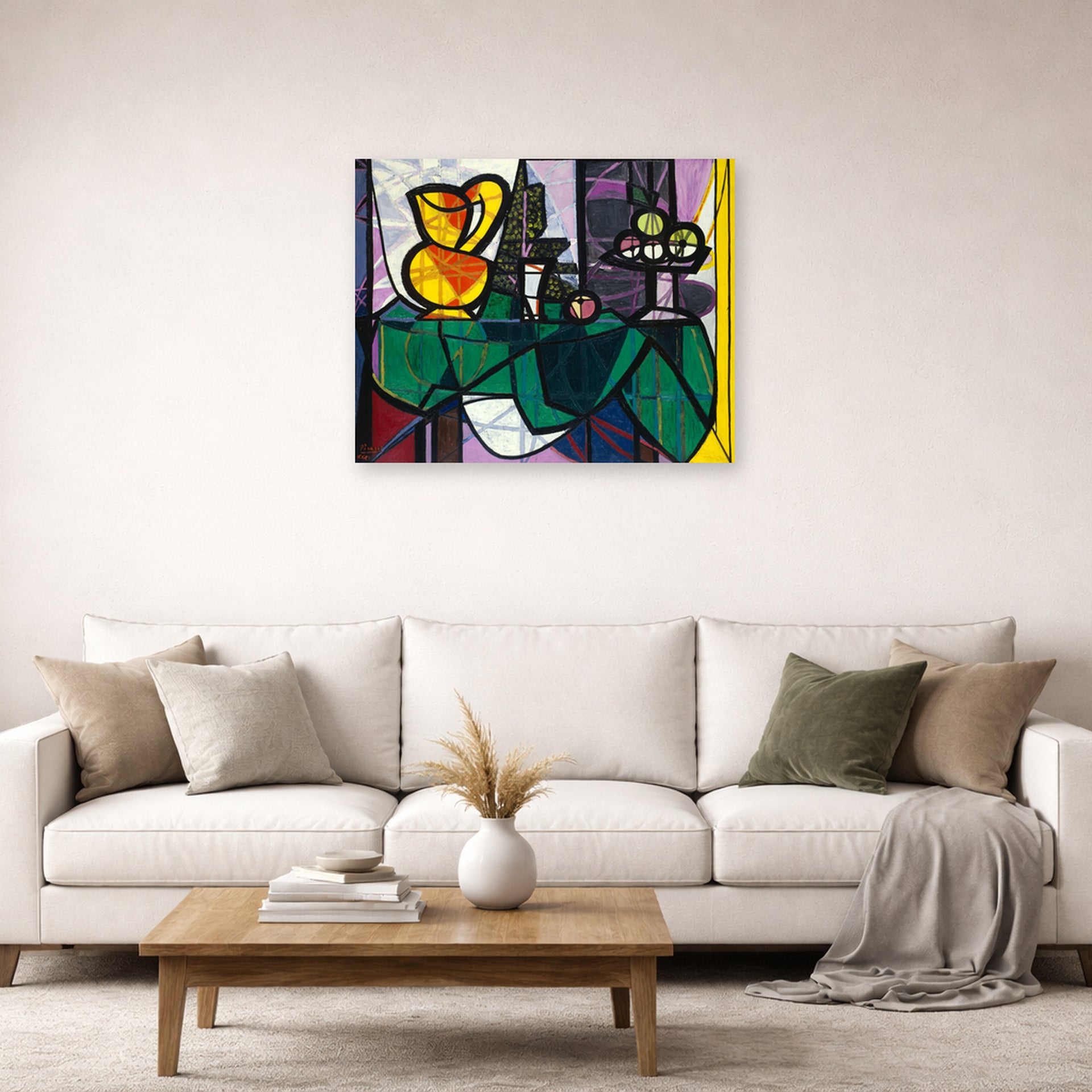 Unframed poster print of Pablo Picasso's 'Pitcher and a Bowl of Fruit' displayed on a wall in a living room