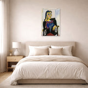 Unframed poster print of Pablo Picasso's 'Portrait of Dora Maar' displayed on a wall in a bedroom