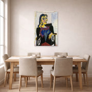 Unframed poster print of Pablo Picasso's 'Portrait of Dora Maar' displayed on a wall in a dining room