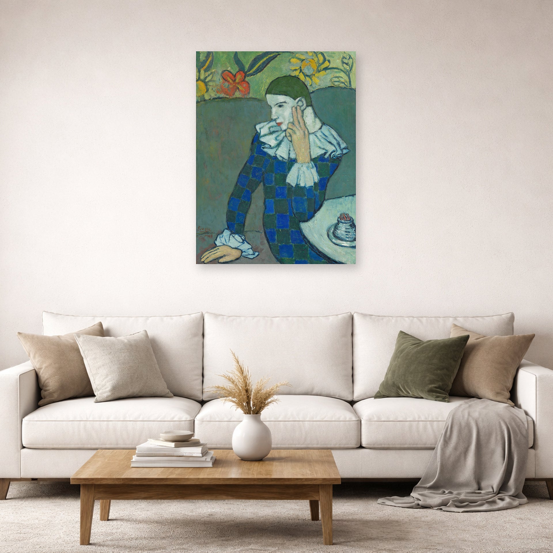 Unframed poster print of Pablo Picasso's 'Seated Harlequin' displayed on a wall in a living room
