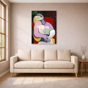 Unframed poster print of Pablo Picasso's 'The Dream' displayed on a wall in a living room