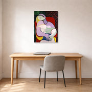 Unframed poster print of Pablo Picasso's 'The Dream' displayed on a wall in a home office