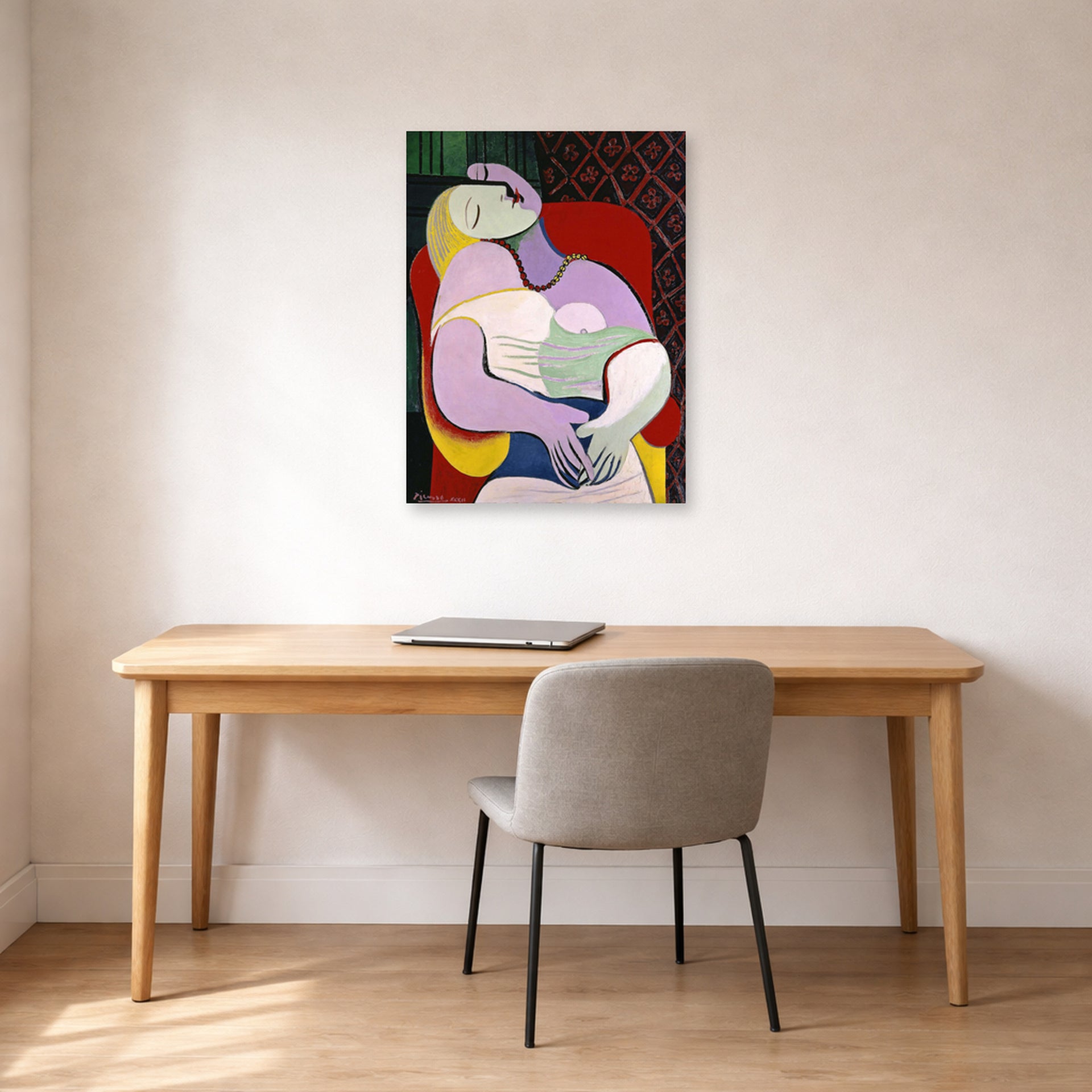 Unframed poster print of Pablo Picasso's 'The Dream' displayed on a wall in a home office