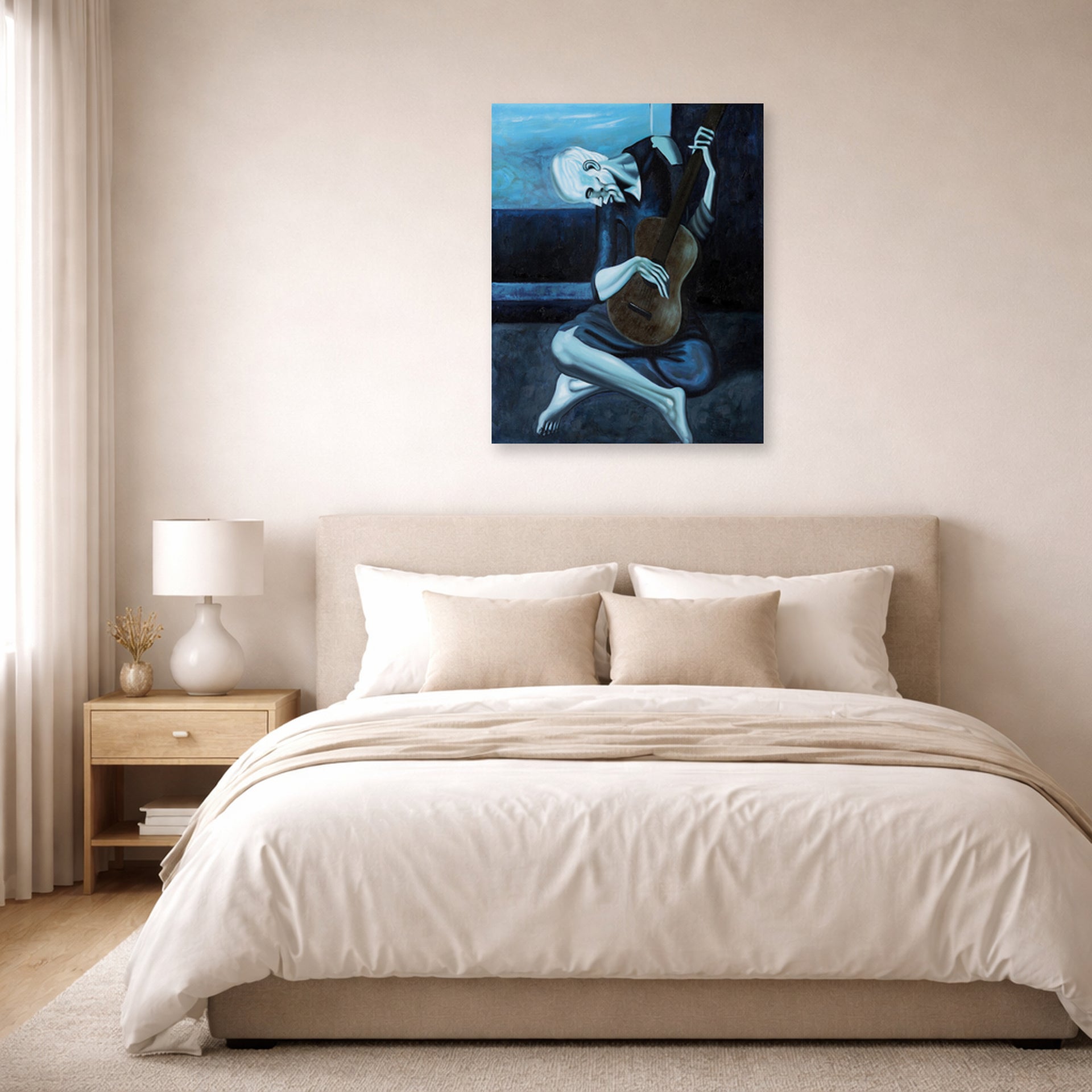 Unframed poster print of Pablo Picasso's 'The Old Guitarist' displayed on a wall in a bedroom