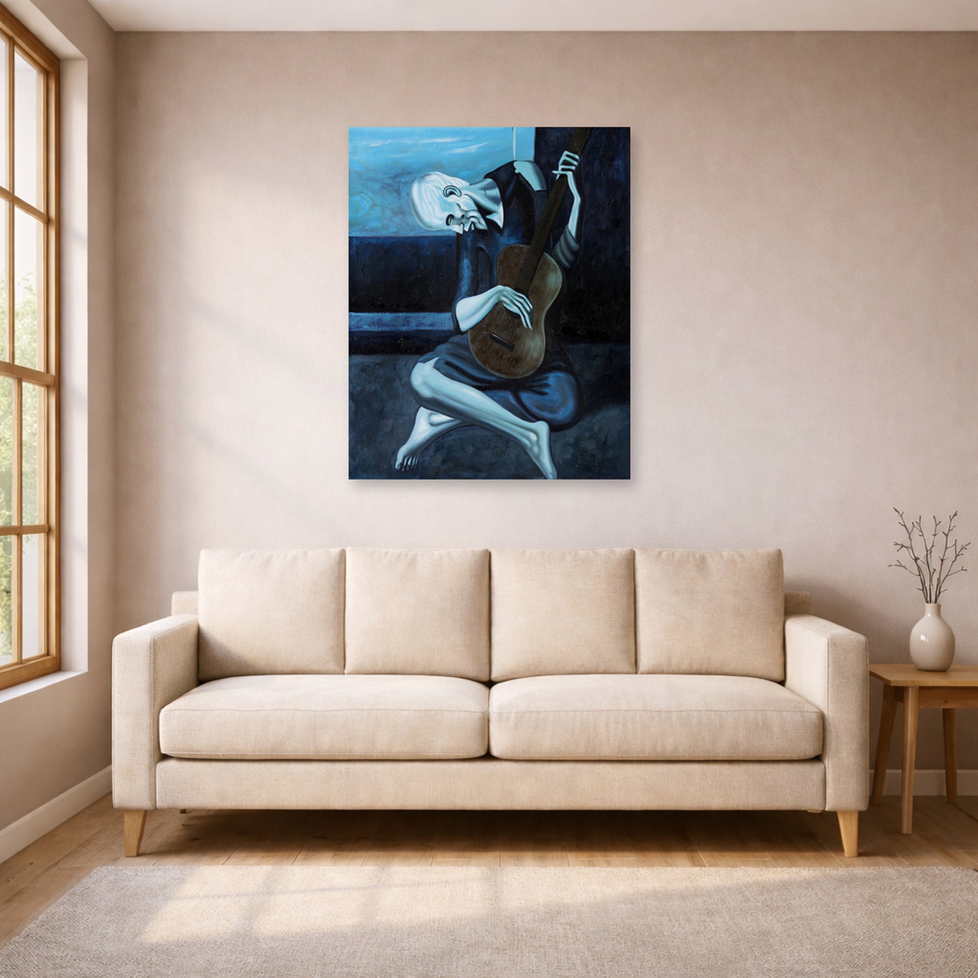 Unframed poster print of Pablo Picasso's 'The Old Guitarist' displayed on a wall in a living room