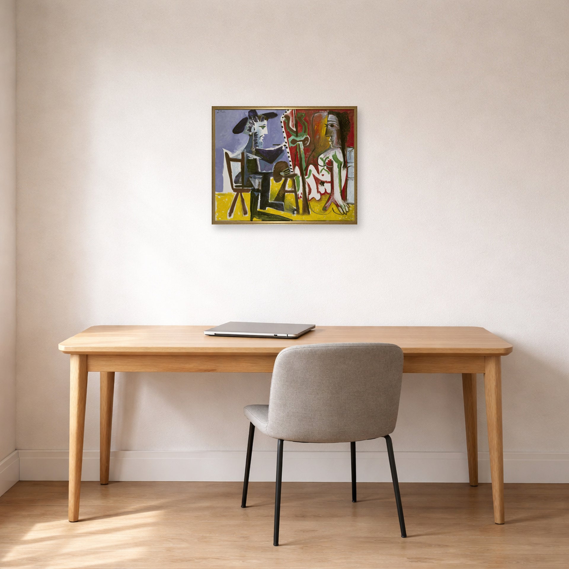 Unframed poster print of Pablo Picasso's 'The Painter and The Model' displayed on a wall in a home office