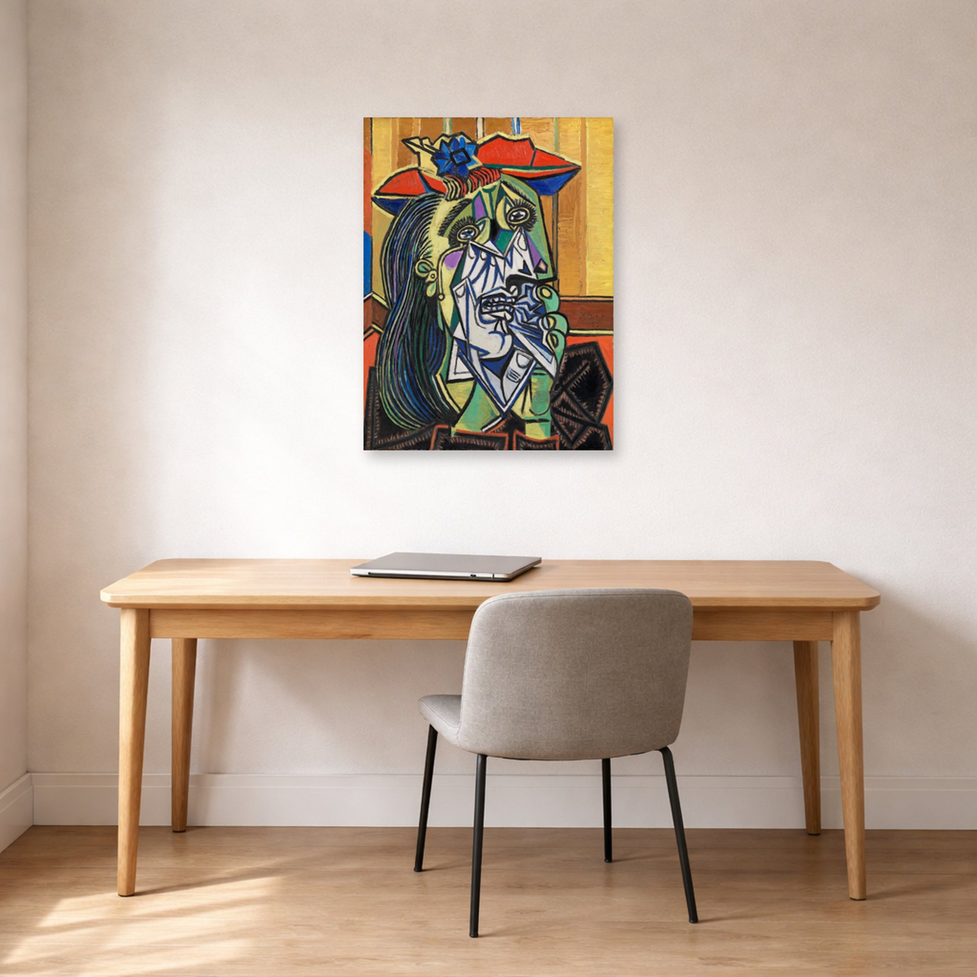 Unframed poster print of Pablo Picasso's 'Weeping Woman' displayed on a wall in a home office