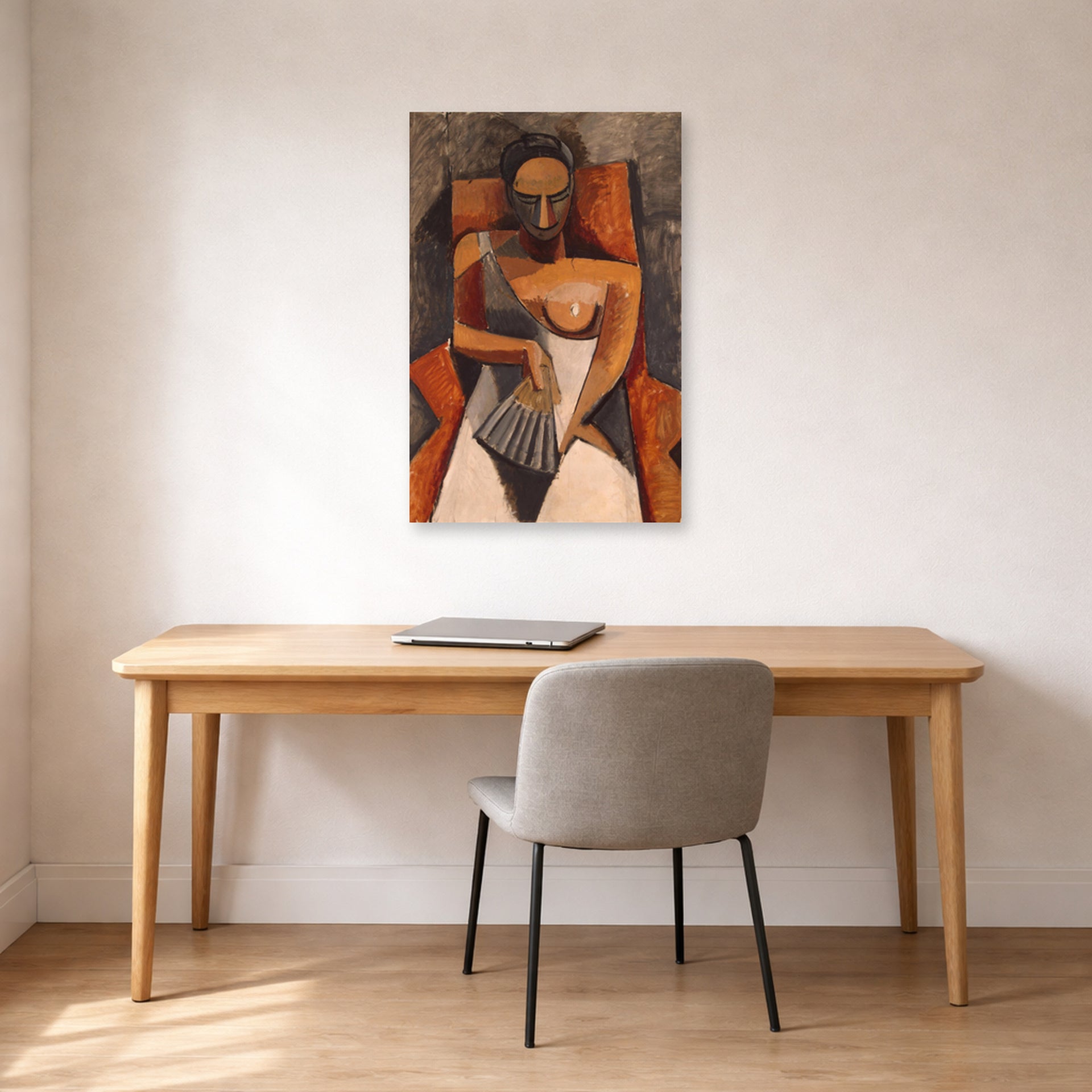 Unframed poster print of Pablo Picasso's 'Woman with a Fan' displayed on a wall in a home office