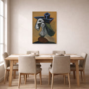 Unframed poster print of Pablo Picasso's 'Woman in a Blue Hat' displayed on a wall in a dining room