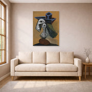 Unframed poster print of Pablo Picasso's 'Woman in a Blue Hat' displayed on a wall in a living room