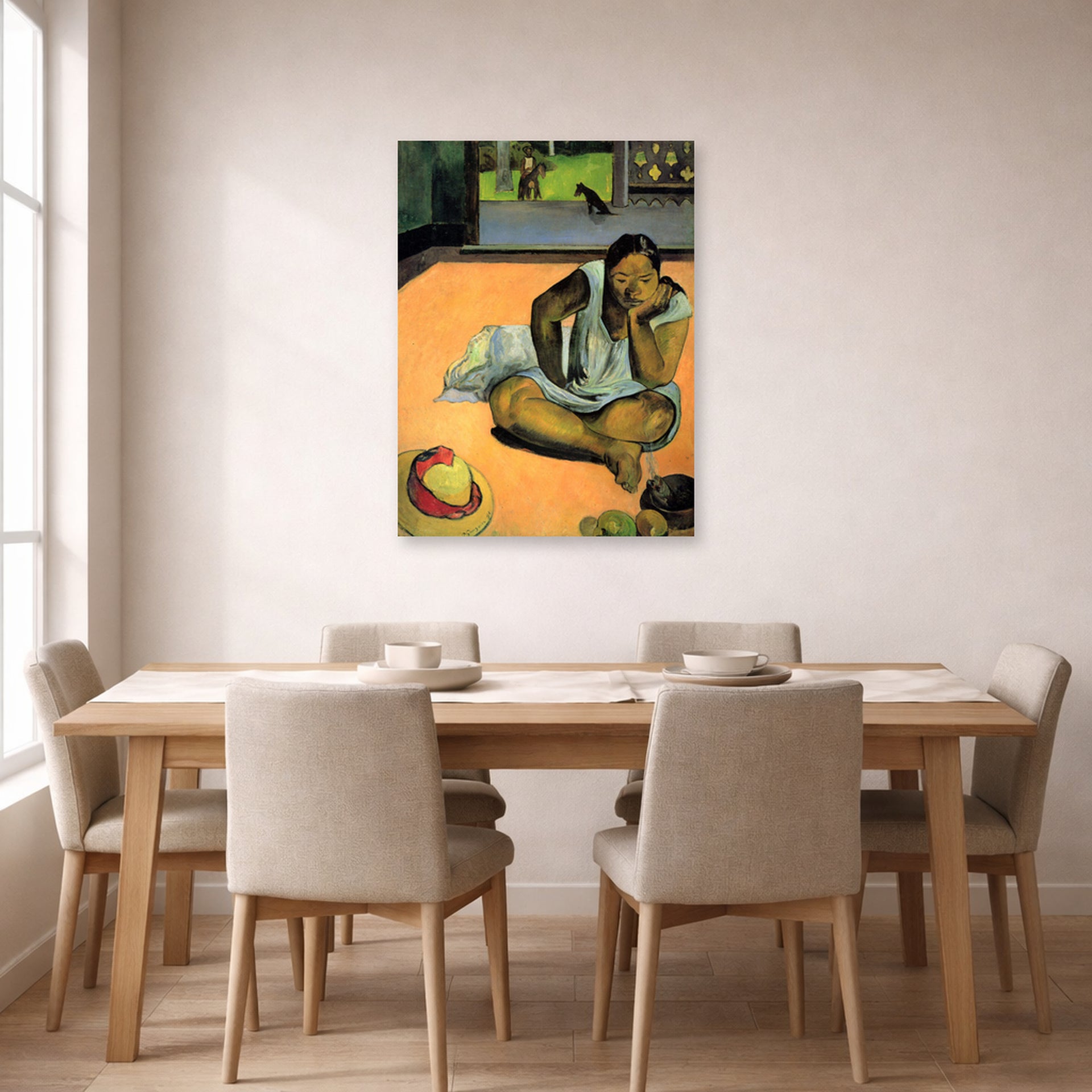 Unframed poster print of Paul Gauguin's The Brooding Woman displayed on a wall in a dining room