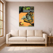 Unframed poster print of Paul Gauguin's The Brooding Woman displayed on a wall in a living room