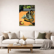 Unframed poster print of Paul Gauguin's The Brooding Woman displayed on a wall in a second living room setting