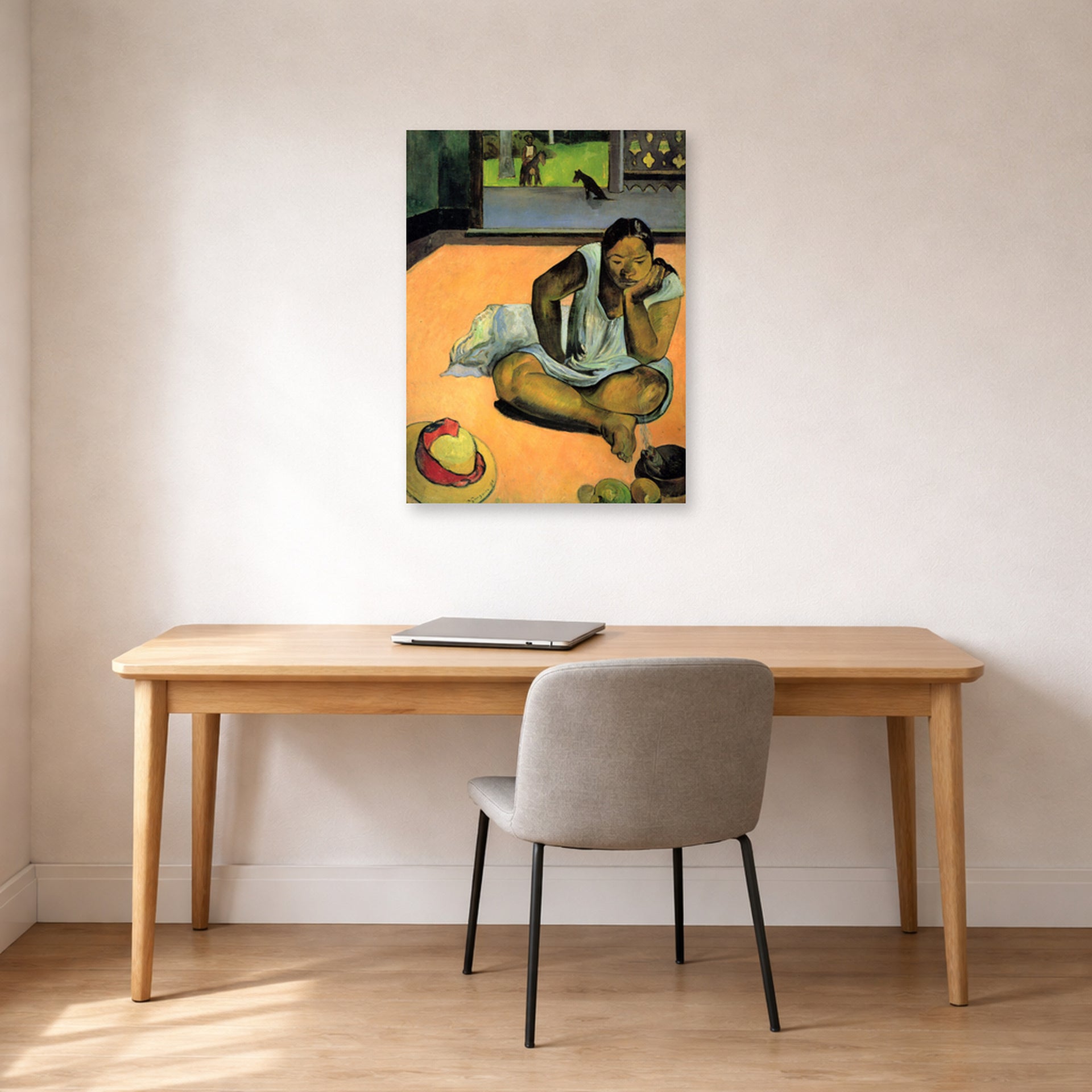 Unframed poster print of Paul Gauguin's The Brooding Woman displayed on a wall in an office