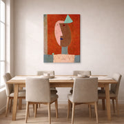 Gallery-wrapped canvas print of Paul Klee's Clown displayed on a wall in a dining room