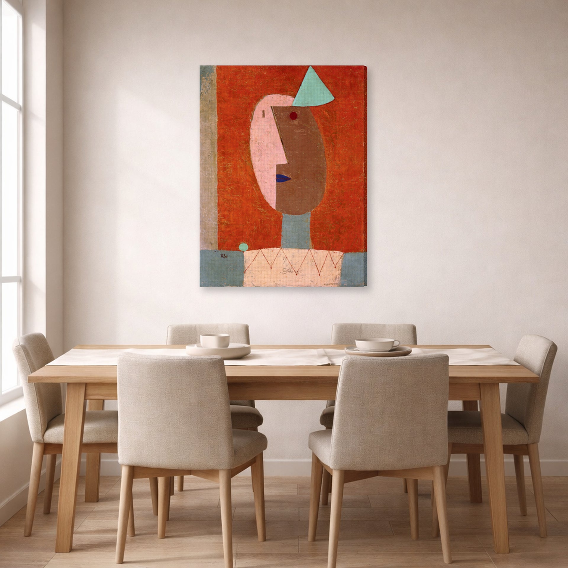 Gallery-wrapped canvas print of Paul Klee's Clown displayed on a wall in a dining room
