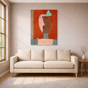 Gallery-wrapped canvas print of Paul Klee's Clown displayed on a wall in a living room