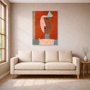 Unframed poster print of Paul Klee's Clown displayed on a wall in a living room