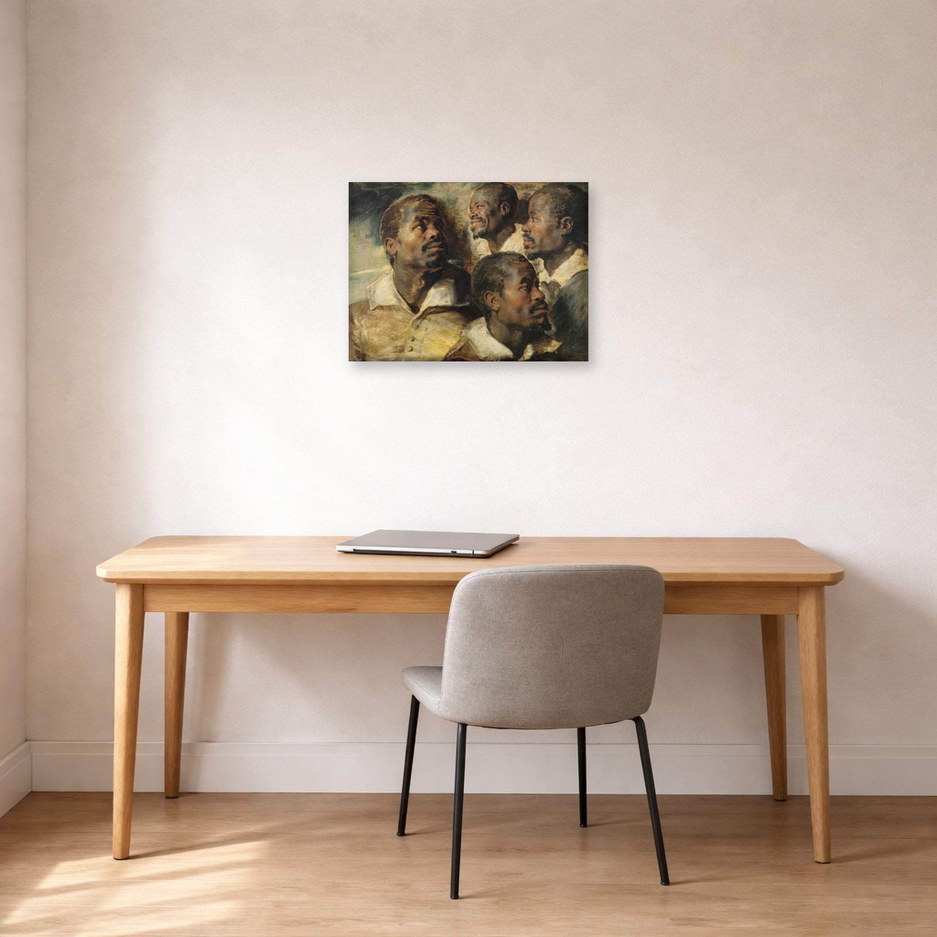 Unframed poster print of Peter Paul Rubens' 'Four Studies of the head of a Moore' displayed on a wall in an office
