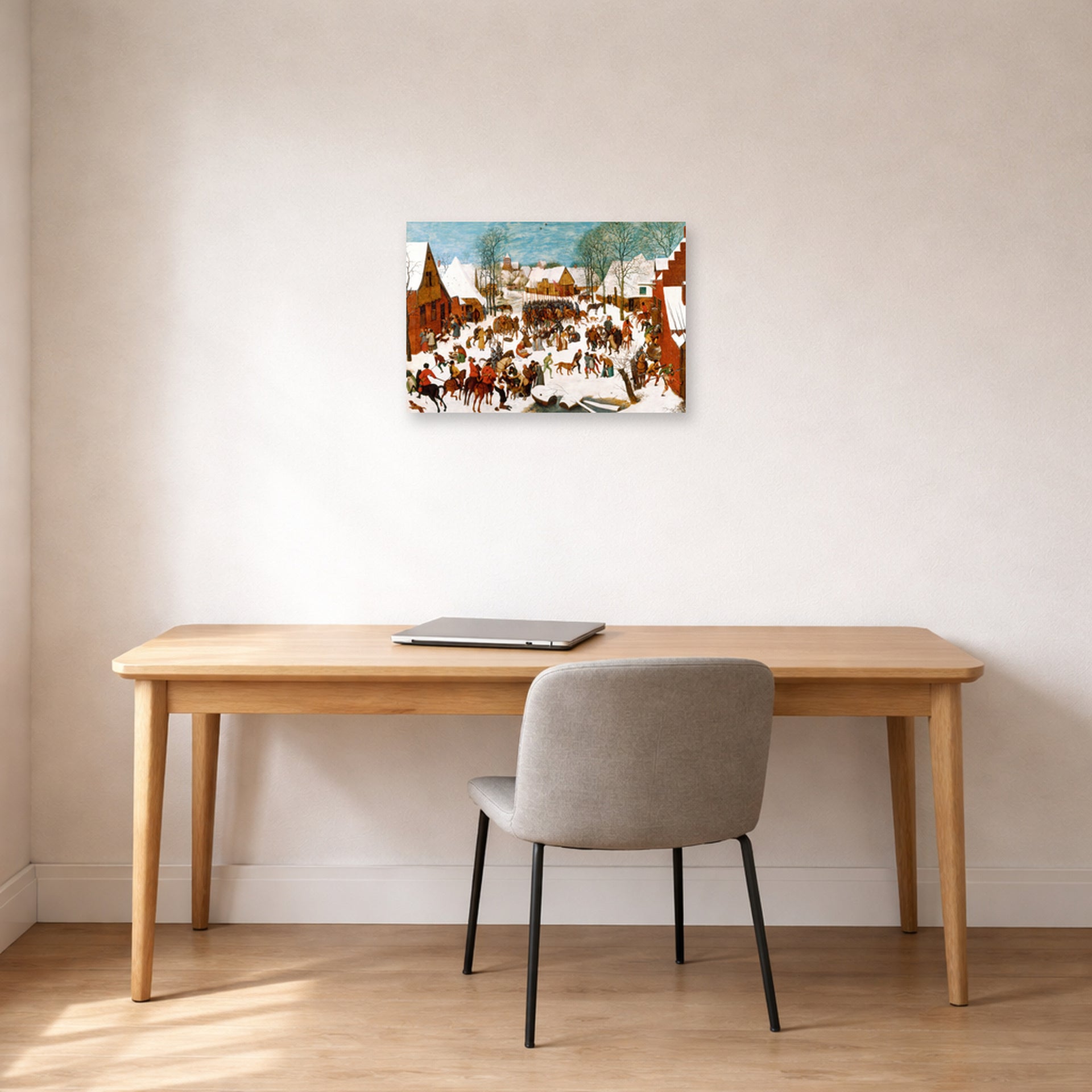 Unframed poster print of Pieter Bruegel the Elder's Massacre of the Innocents displayed on a wall in a home office