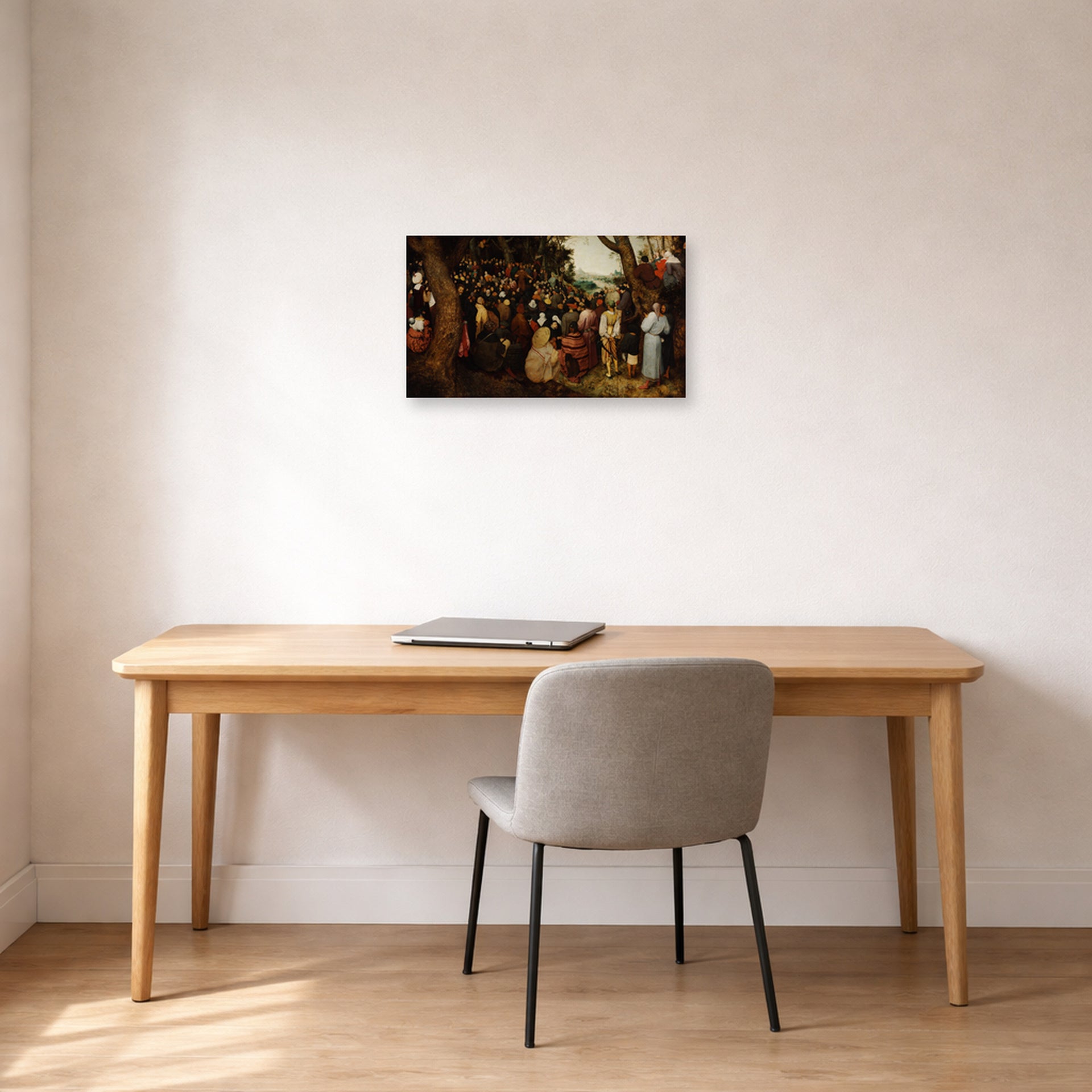 Unframed poster print of Pieter Bruegel the Elder's The Sermon of Saint John the Baptist displayed on a wall in a home office