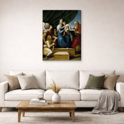 Gallery-wrapped canvas print of Raphael's The Holy Family with St. Raphael, Tobias and St. Jerome displayed on a wall in a living room