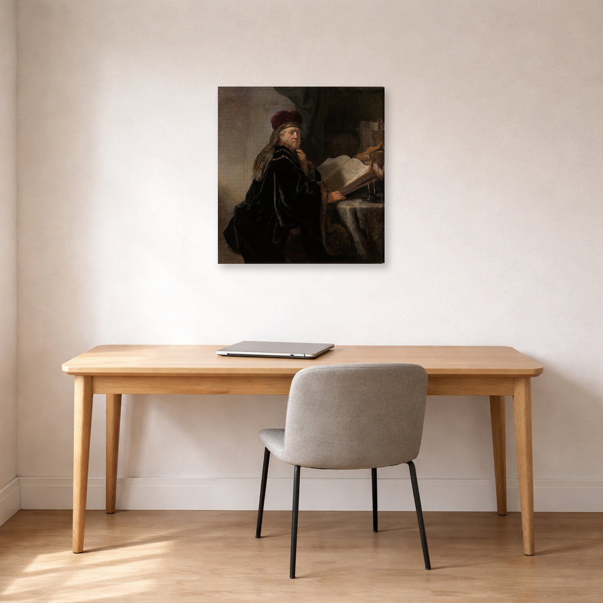 Gallery-wrapped canvas print of Rembrandt's A Scholar Seated at a Desk displayed on a wall in an office